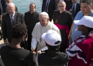 Pope Francis speaks to migrants, some wearing white caps, during his visit to the island of Lampedusa, southern Italy, Monday July 8, 2013. Pope Francis traveled Monday to the tiny Sicilian island of Lampedusa to pray for migrants lost at sea, going to the farthest reaches of Italy to throw a wreath of flowers into the sea and celebrate Mass as yet another boatload of Eritrean migrants came ashore. (AP Photo/Alessandra Tarantino, pool)